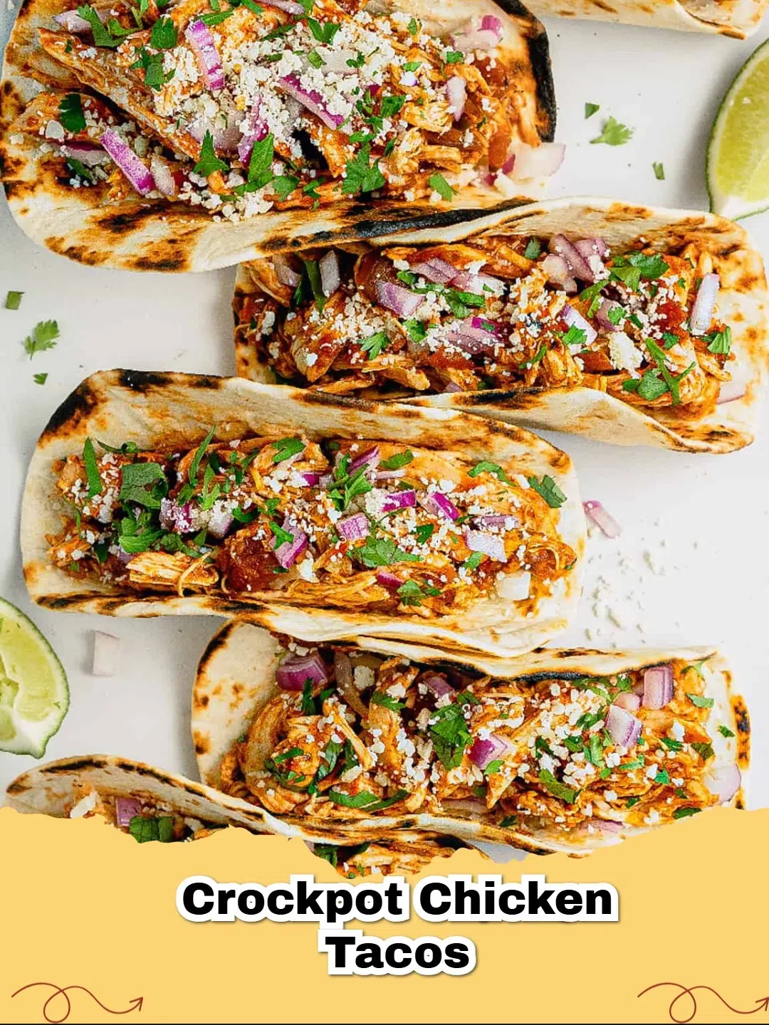 Delicious crockpot shredded chicken tacos piled high with fresh cilantro, diced red onion, and crumbled Cotija cheese.