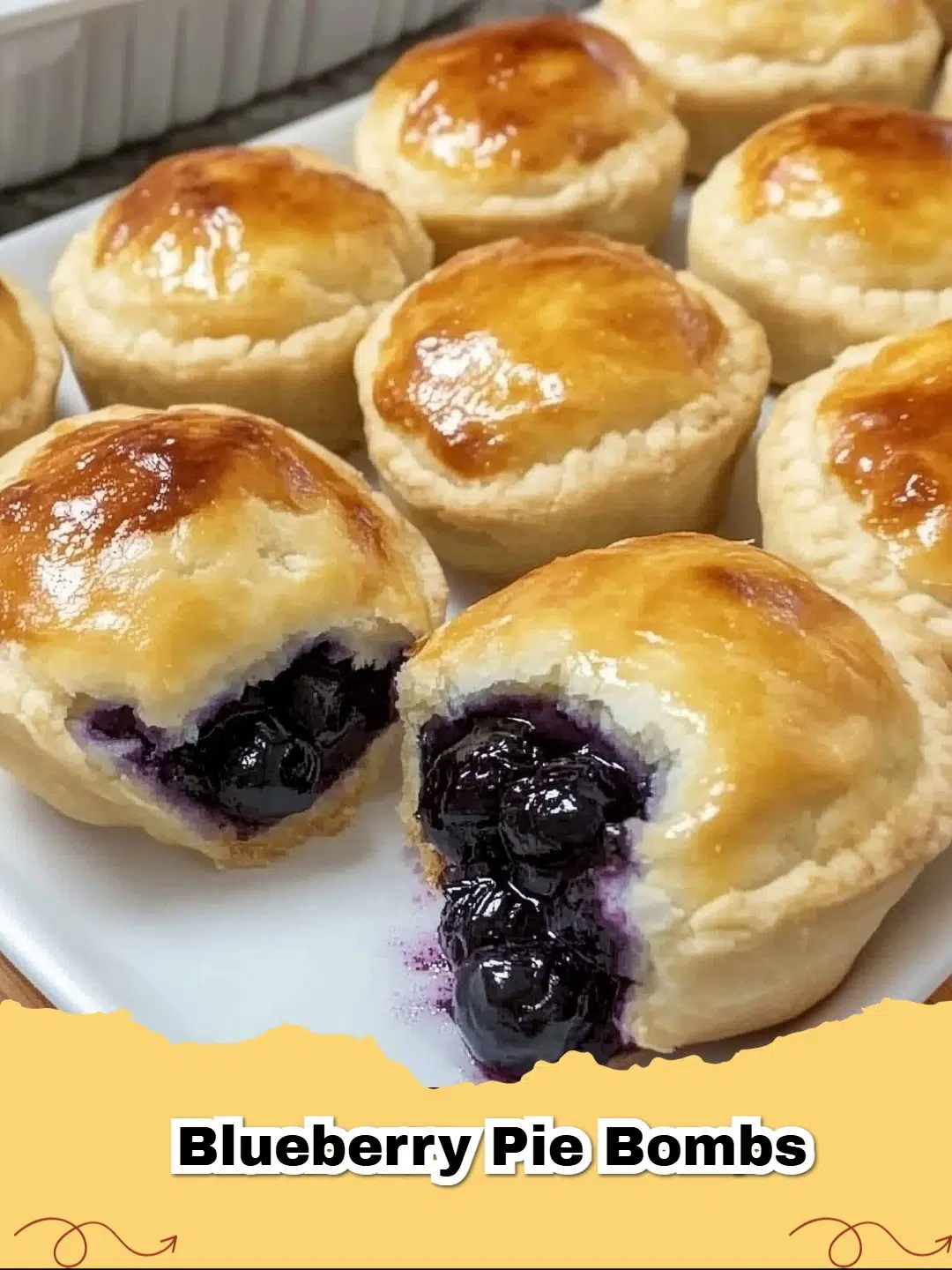 Golden-brown Blueberry Pie Bombs with a dollop of cream cheese glaze, fresh blueberries, and a dusting of powdered sugar.