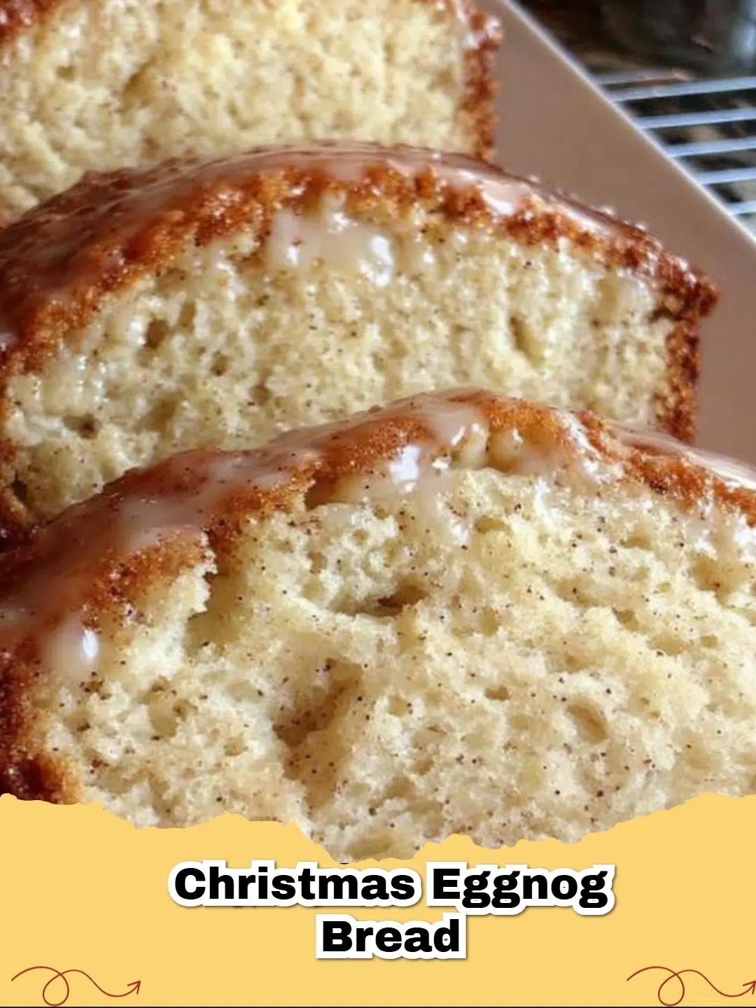 A moist slice of golden brown Christmas Eggnog Bread with a dusting of powdered sugar, ready to be served.
