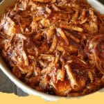 Deliciously tender Crockpot BBQ Chicken piled high on a bun with a side of coleslaw, ready to serve for dinner.