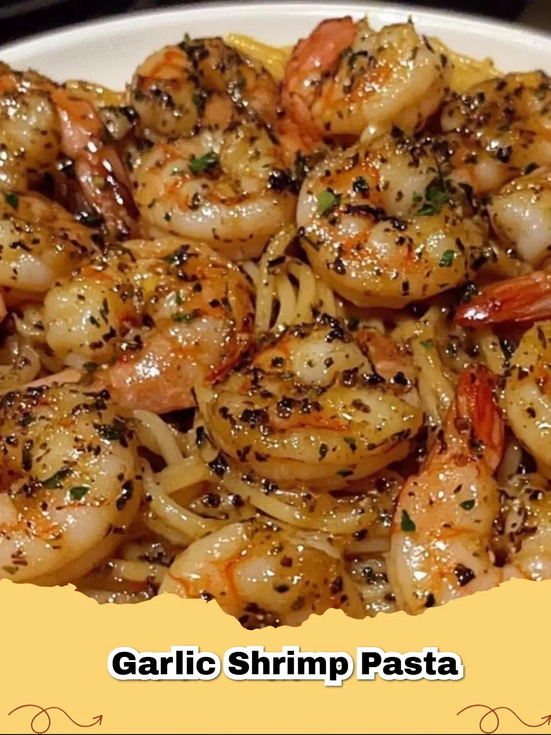 Close-up of a plate of delicious garlic butter shrimp pasta with spaghetti, red pepper flakes, and fresh parsley.