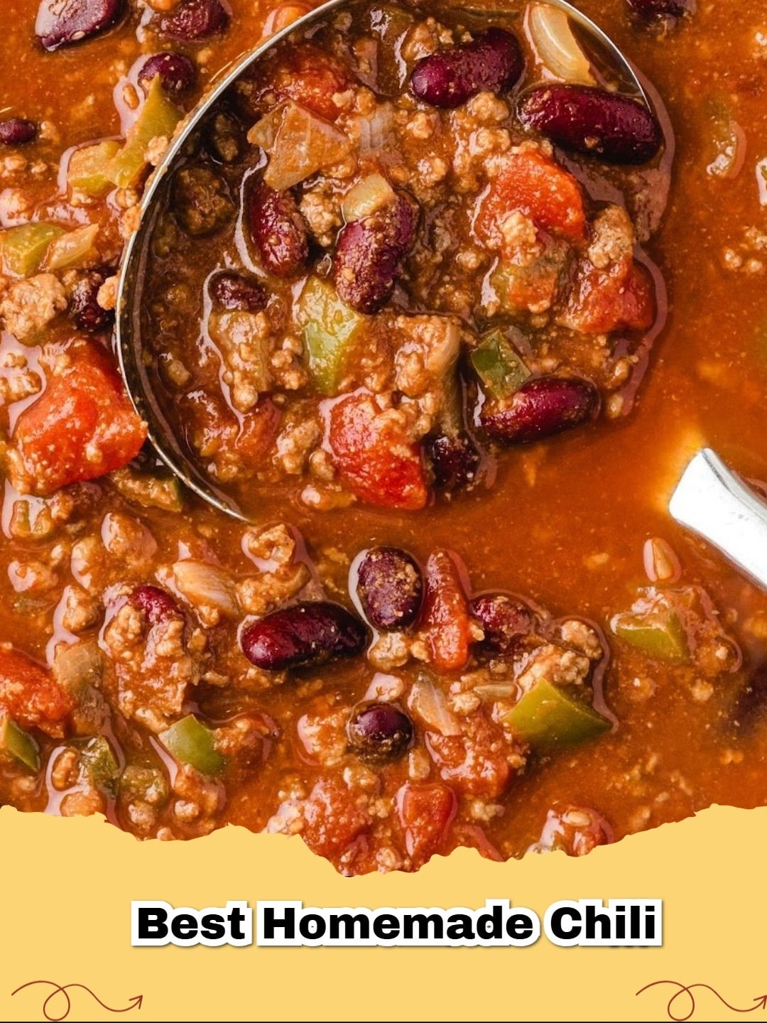 A steaming bowl of easy homemade chili topped with shredded cheddar cheese and a dollop of sour cream