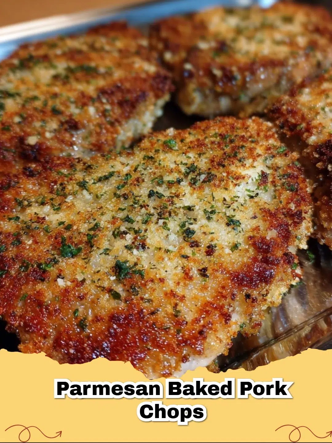 Deliciously golden brown Parmesan Baked Pork Chops with fresh parsley garnish on a plate.