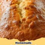 Deliciously moist easy spiced applesauce bread loaf on a cutting board, garnished with powdered sugar.