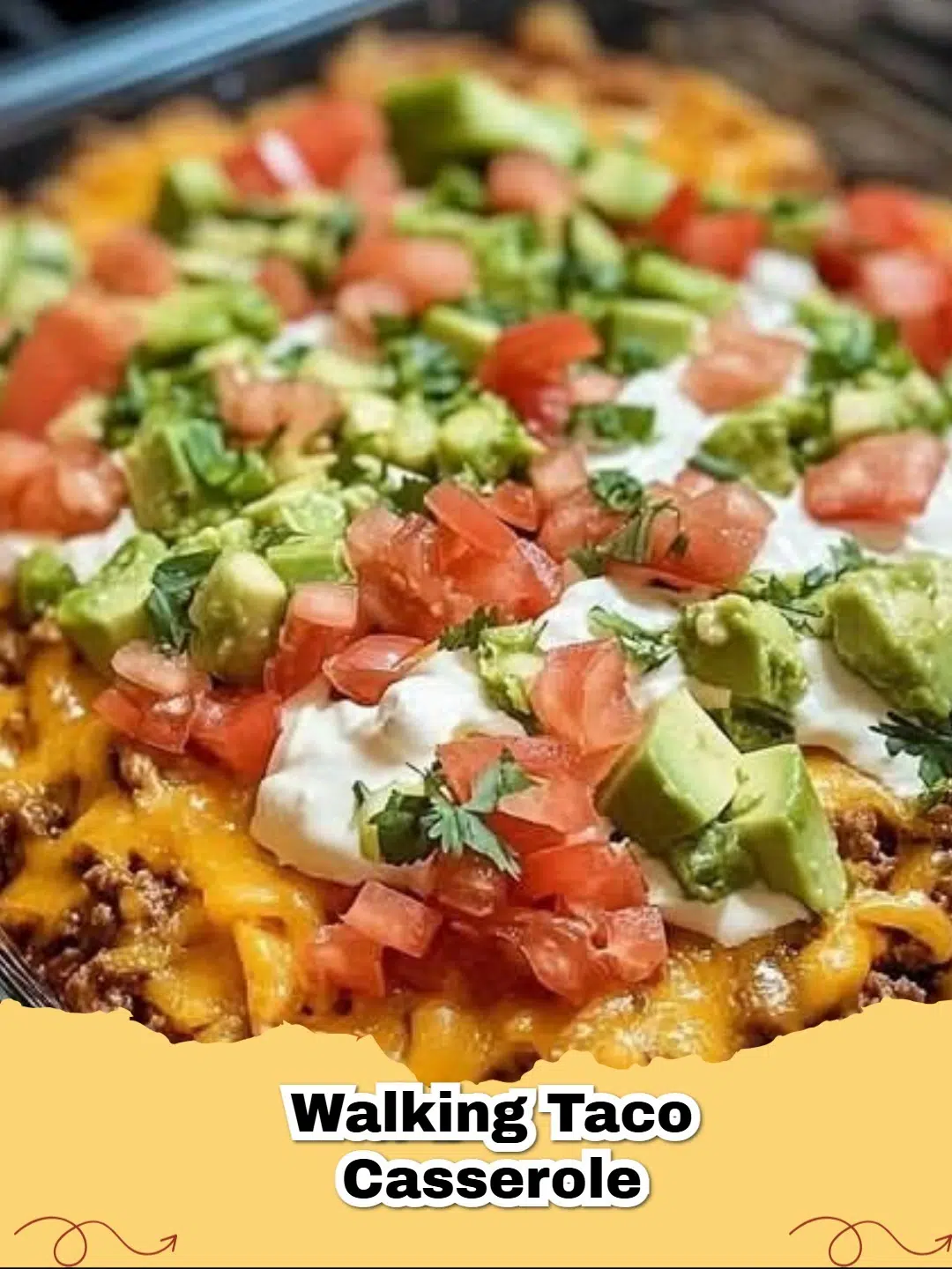 A vibrant Easy Walking Taco Casserole topped with fresh lettuce, tomatoes, and sour cream, ready to be served.