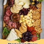 A bountiful and elegant Thanksgiving Cheese Board adorned with cheeses, seasonal fruits, nuts, crackers, and rosemary for holiday entertaining.