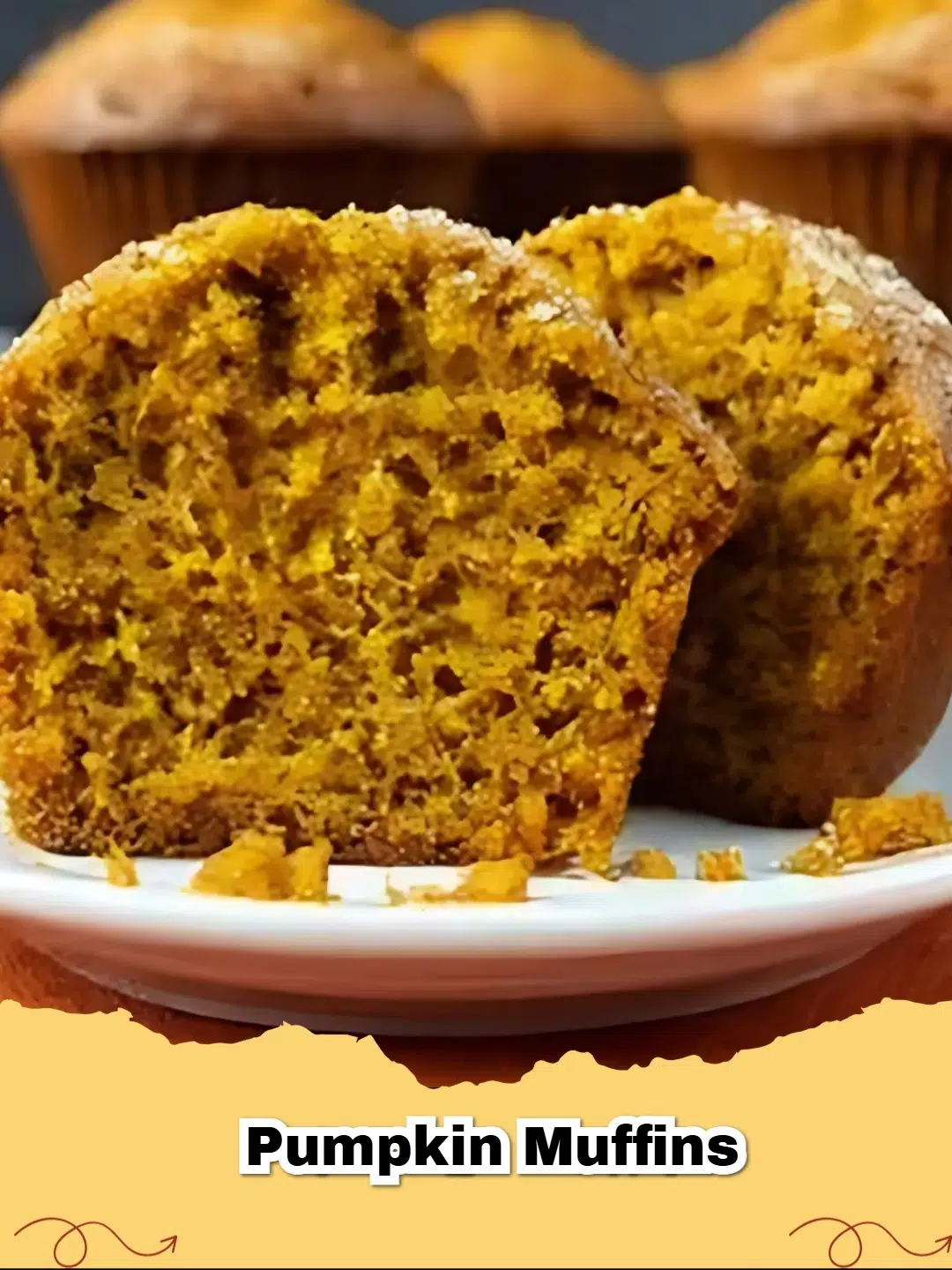 Close-up of a stack of fluffy homemade pumpkin muffins with a light sprinkle of sugar on top, perfect for a fall breakfast.