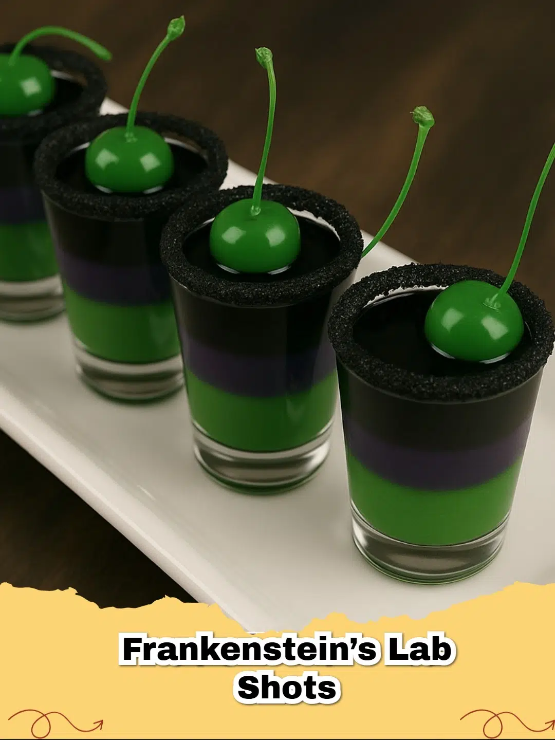 Frankenstein's Lab Shots with black sugar rim and green cherry garnish, perfect for a spooky Halloween party