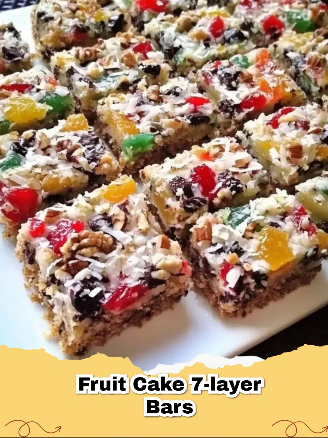 Close-up of baked Fruit Cake Magic Bars with layers visible, ready to be served on a festive platter.