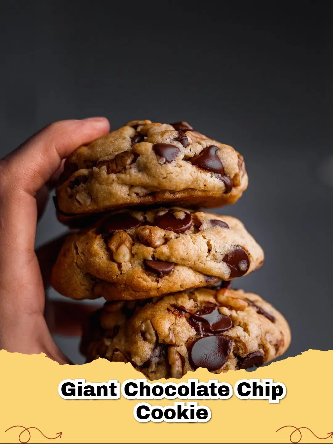 Close-up of freshly baked giant chocolate chip walnut cookies on a cooling rack, showing melted chocolate and walnuts.