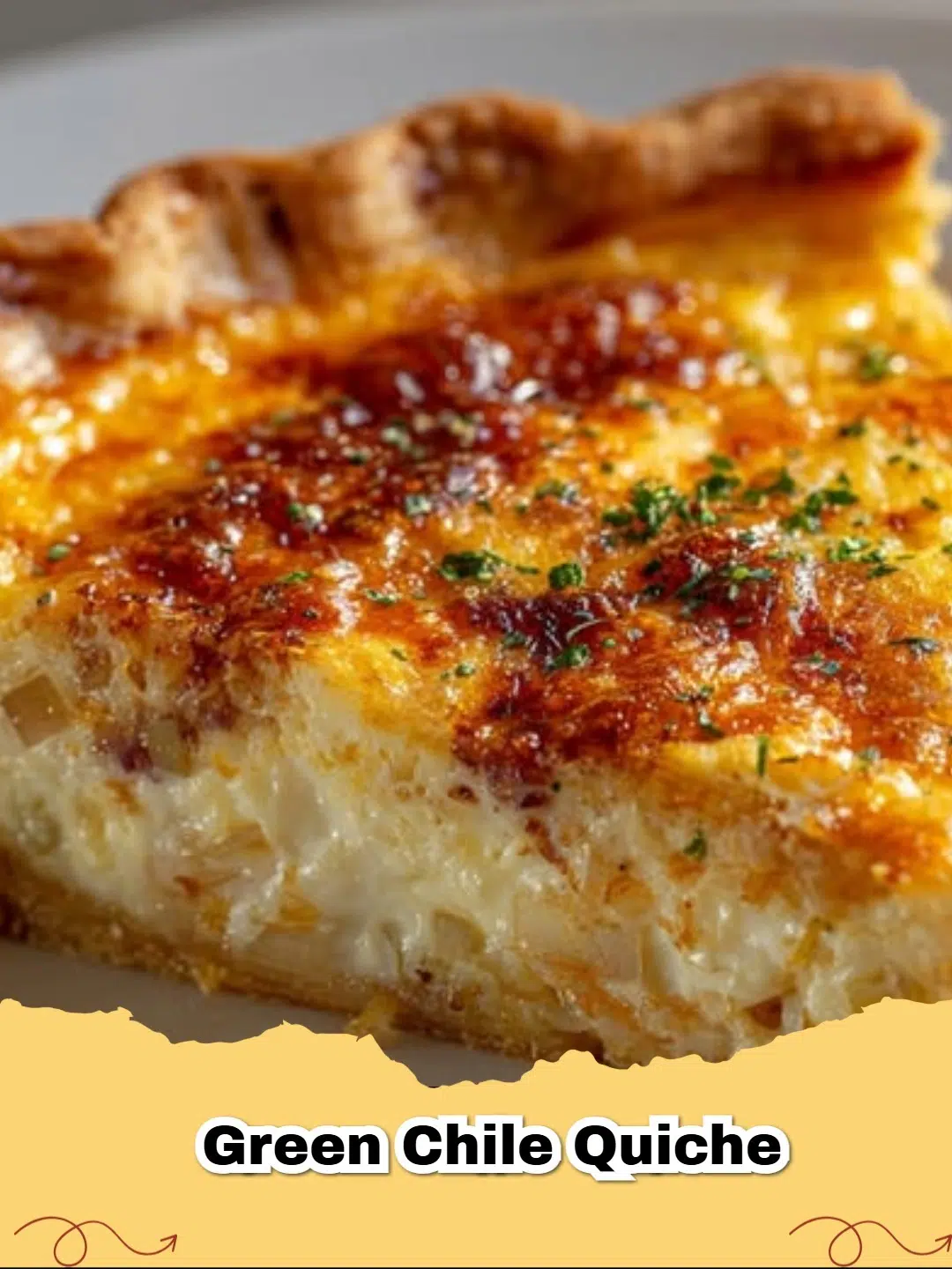 Close-up of a slice of golden-brown Green Chile Quiche with cheese and green chiles visible, ready to be served on a white plate.