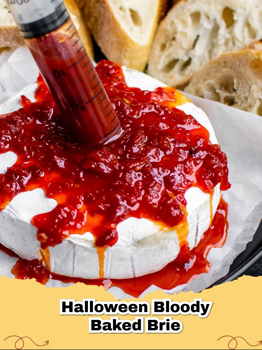 Bloody Baked Brie, a spooky Halloween appetizer with raspberry jam 'blood' and puff pastry decoration.