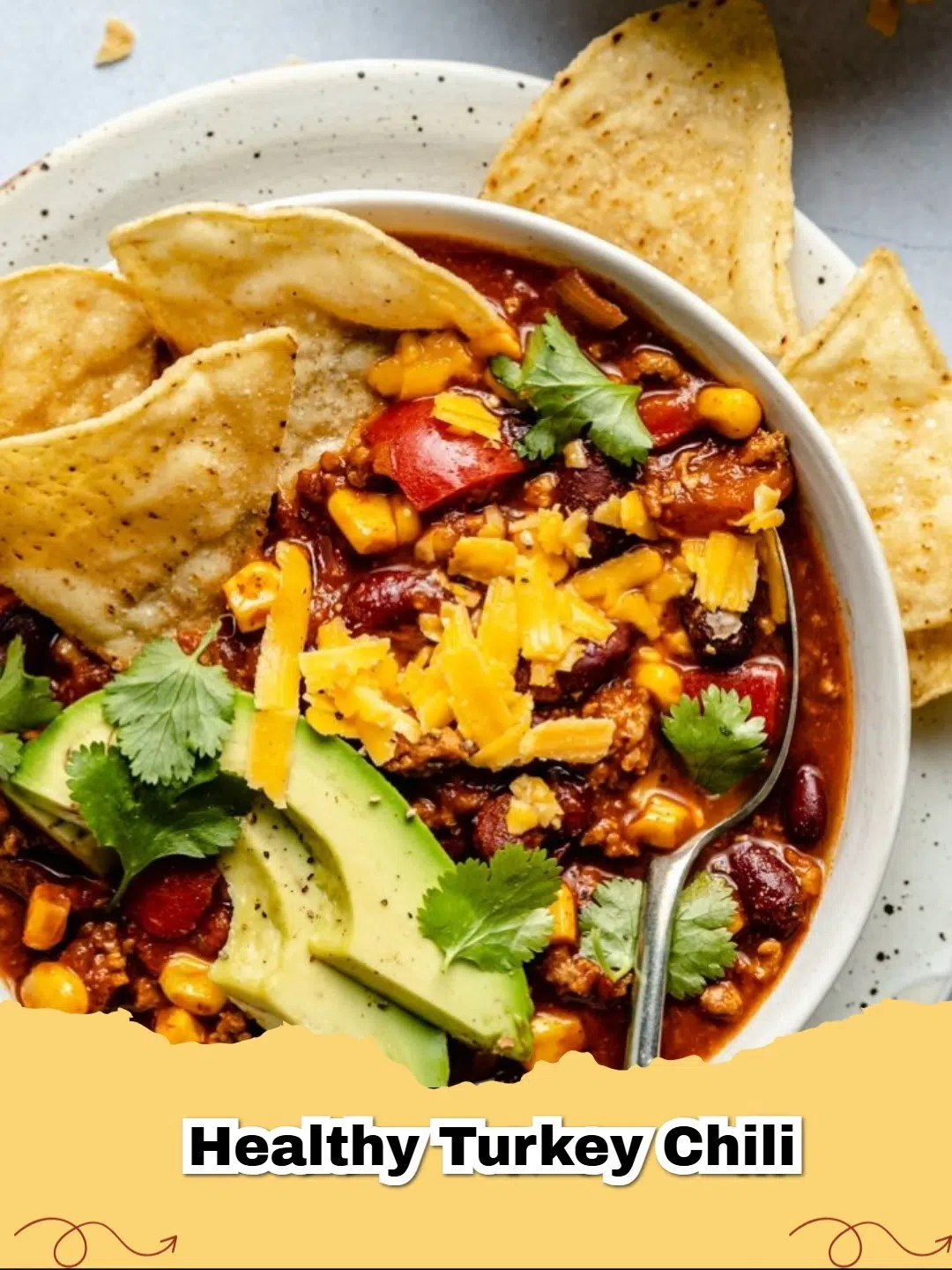 A cozy bowl of healthy and hearty turkey chili, garnished with fresh cilantro and shredded cheese, ready to be enjoyed.