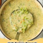 A steaming bowl of creamy High Protein Broccoli Cheddar Soup garnished with fresh parsley and shredded cheddar.