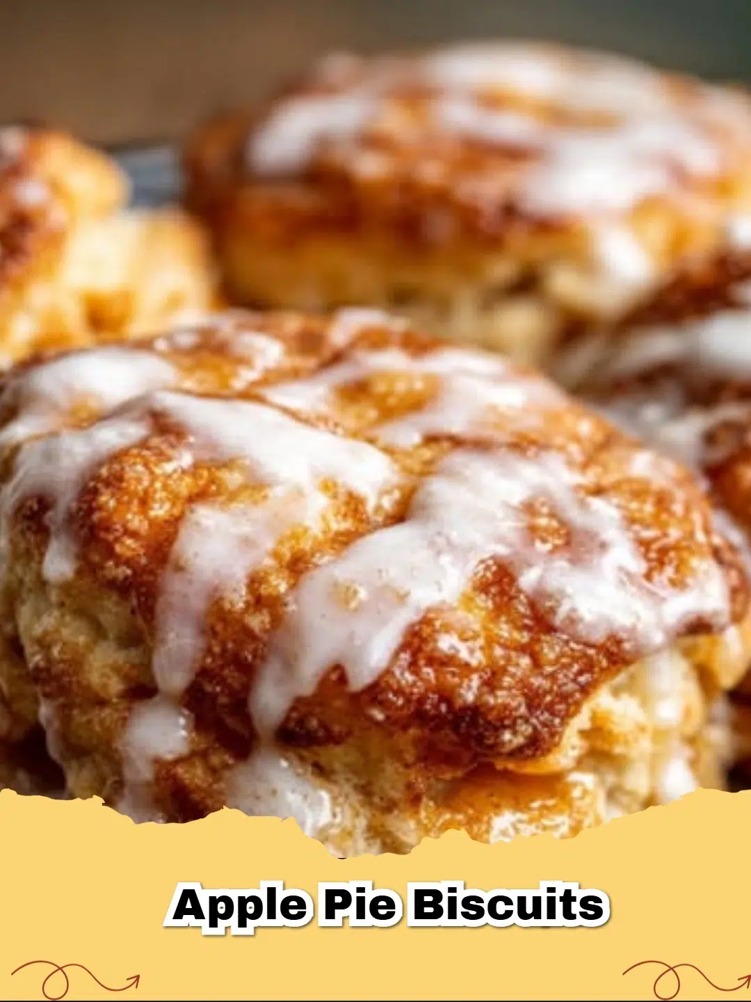 Close-up of golden brown apple pie biscuits drizzled with white glaze on a cooling rack.