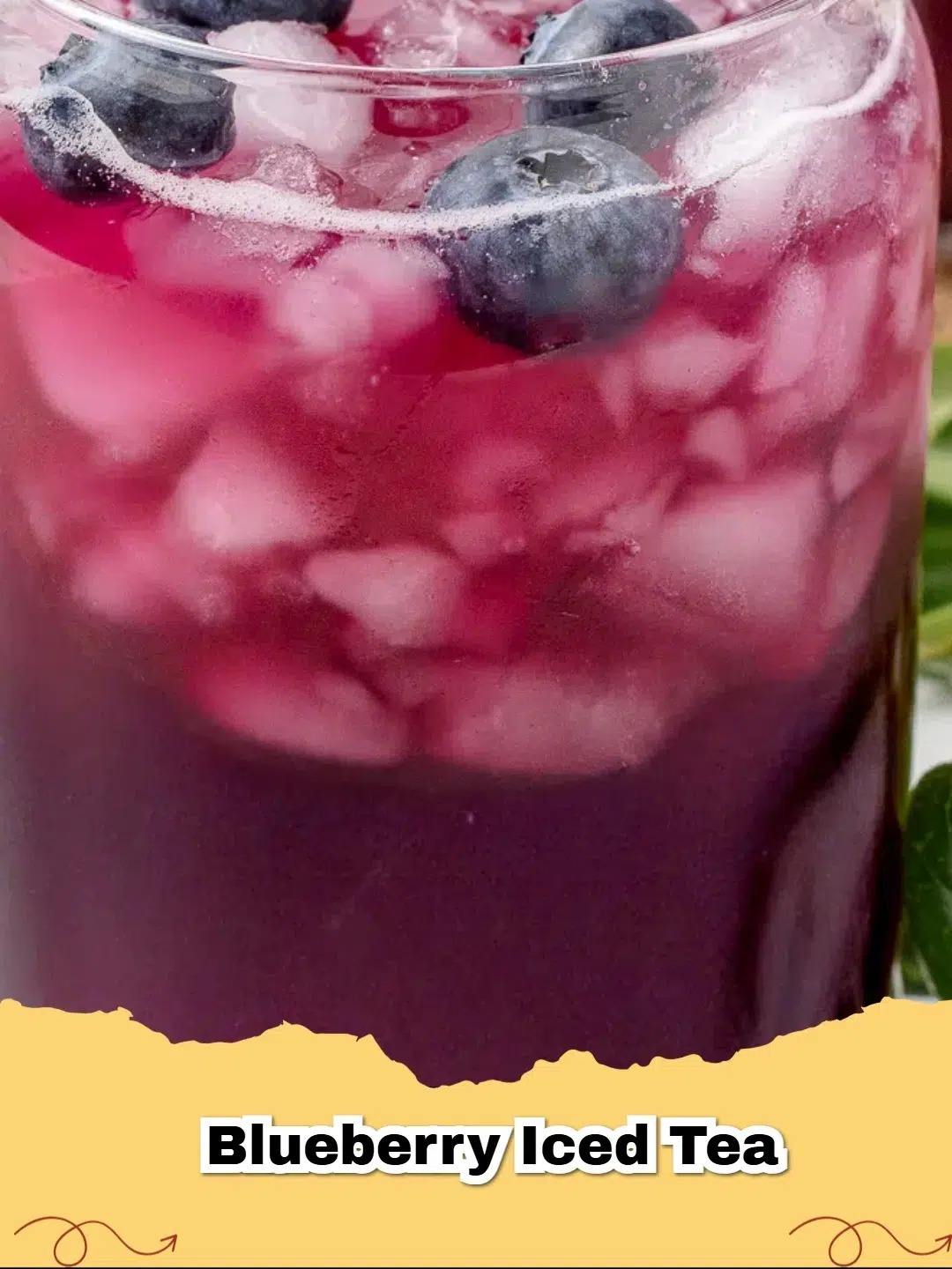 Refreshing glass of homemade blueberry iced tea with fresh blueberries and lemon slices