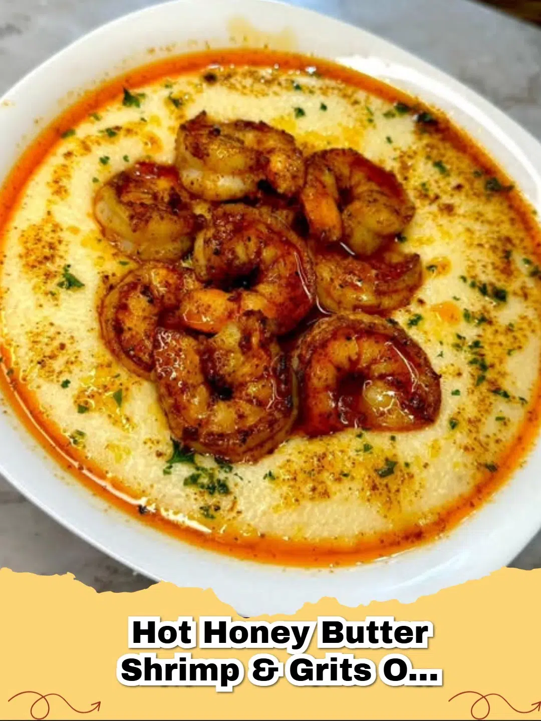 A close-up of hot honey butter shrimp and creamy smoked Gouda grits garnished with green onions.