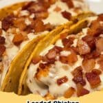 Close-up of golden-brown Loaded Chicken Bacon Ranch Taco Bell Bombs on a baking sheet, with creamy filling visible.