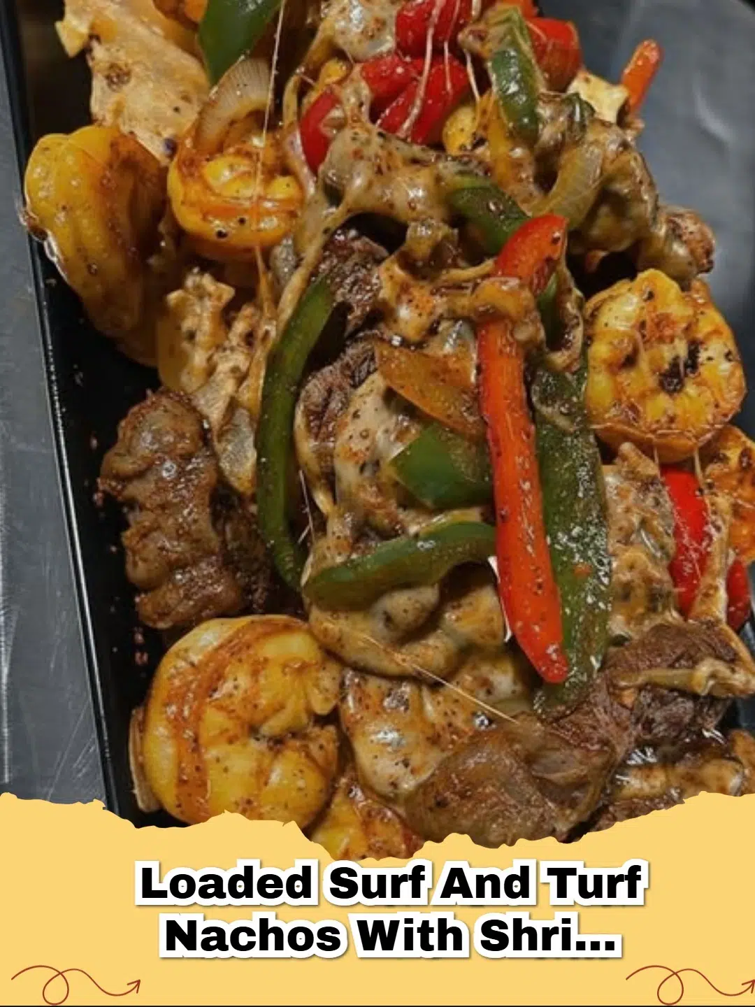 A generous platter of loaded surf and turf nachos with steak, shrimp, bell peppers, and melted cheese, garnished with cilantro and jalapeƱos.