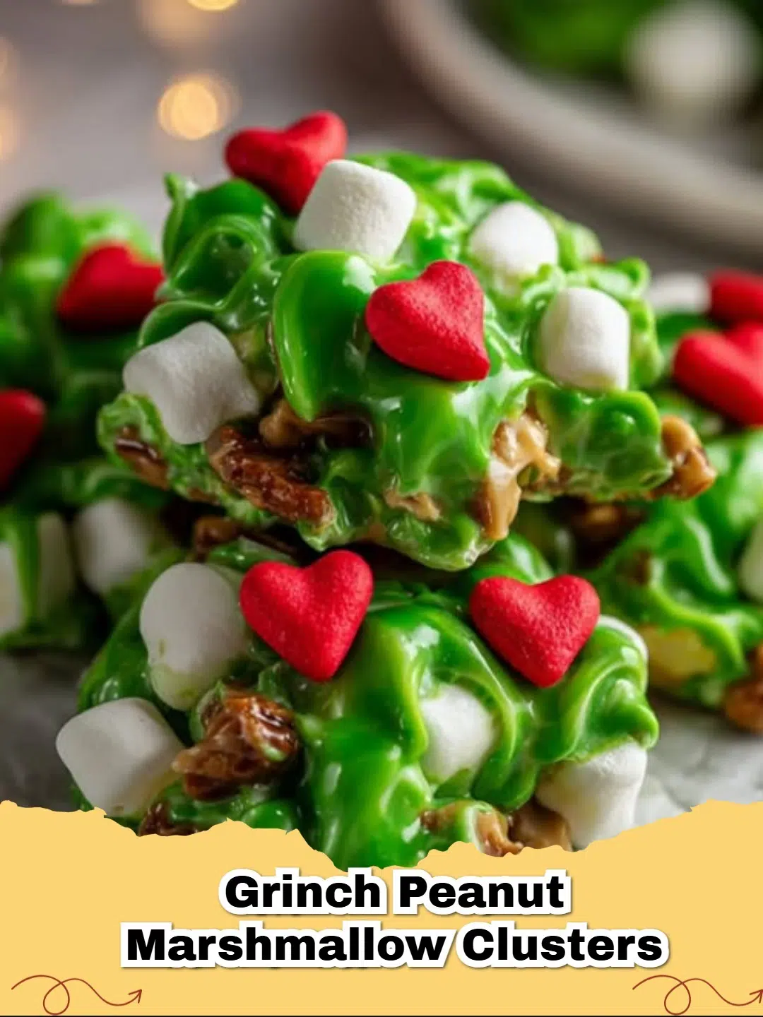 Close-up of festive No-Bake Grinch Peanut Butter Marshmallow Clusters on parchment paper, topped with red heart sprinkles.