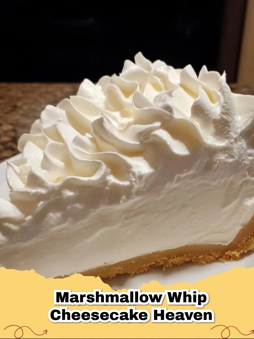 A slice of creamy No-Bake Marshmallow Fluff Cheesecake with a graham cracker crust and a fluffy marshmallow topping, garnished with mini marshmallows.
