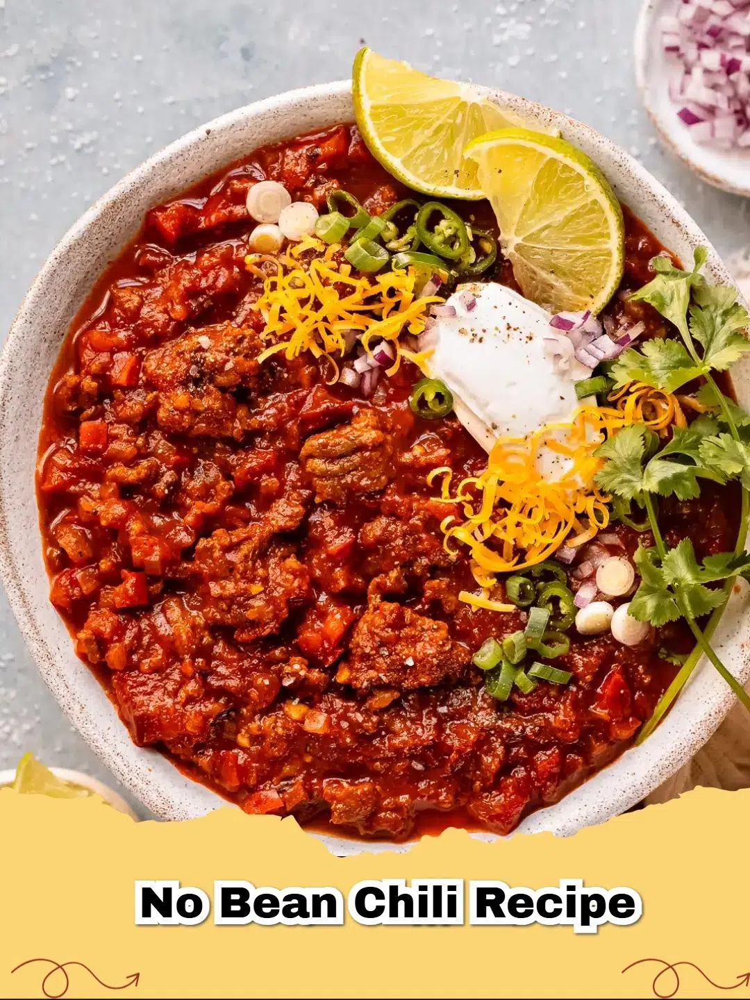 Hearty bowl of no bean chili topped with cheese and sour cream