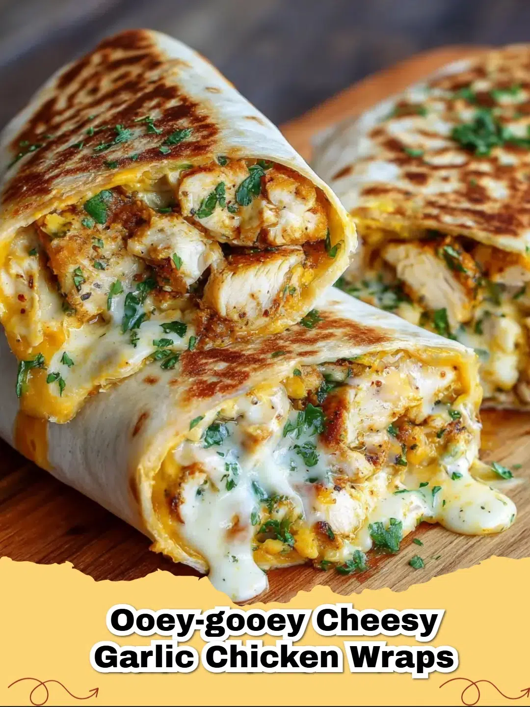 A close-up of an Ooey-Gooey Cheesy Garlic Chicken Wrap, sliced in half, showing the melted cheese and tender chicken filling.