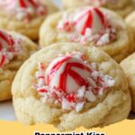 A plate of festive Peppermint Hershey Kiss Sugar Cookies with red and white peppermint swirls.
