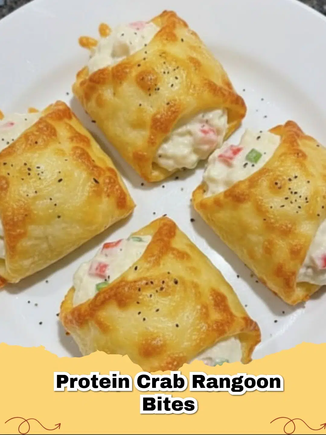 Baked protein crab rangoon bites served on a platter with sweet chili dipping sauce.