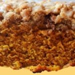 Delicious homemade Pumpkin Streusel Bread with a golden-brown crumbly topping, ready to serve for a fall treat.