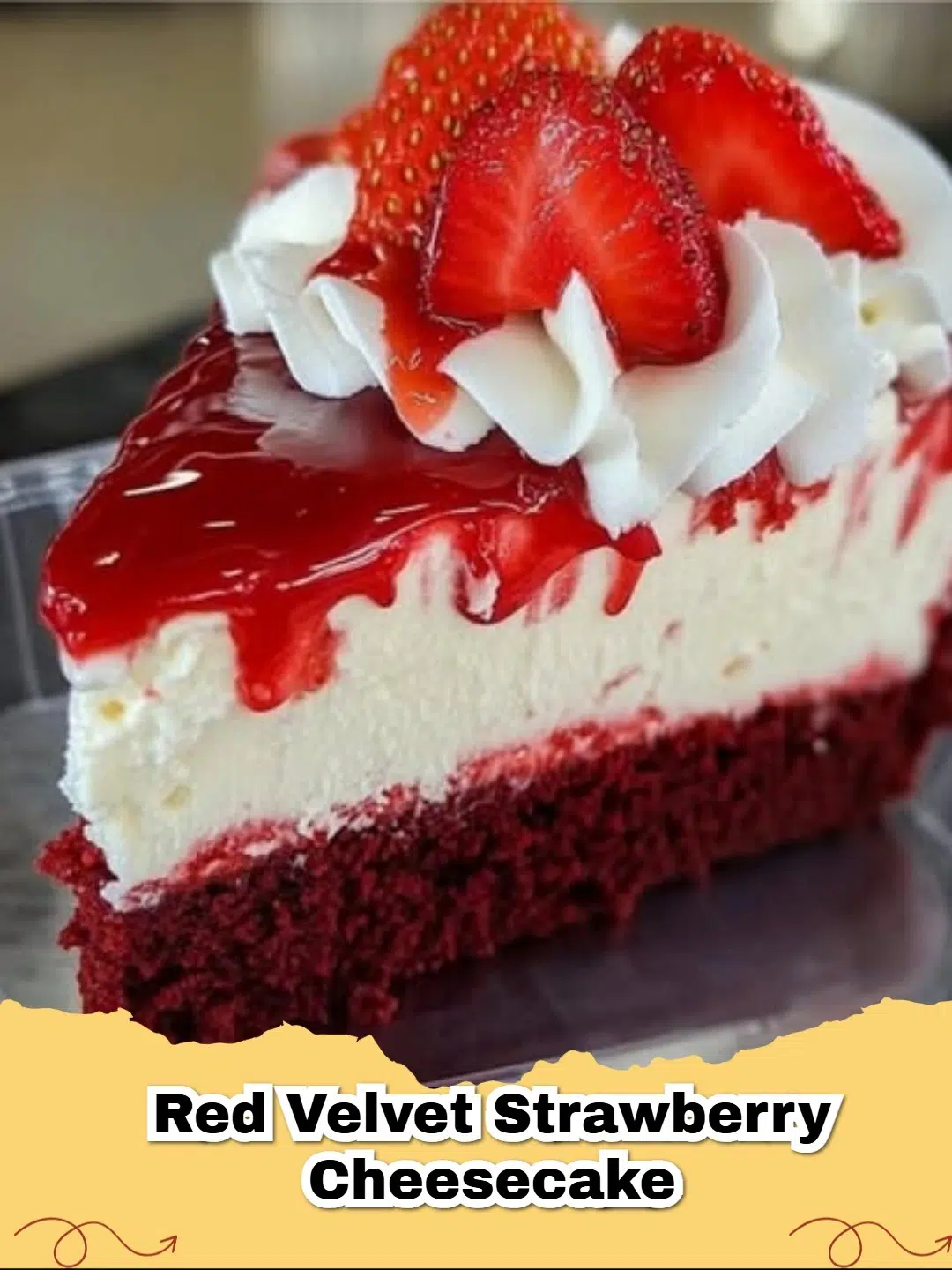 A stunning slice of Red Velvet Strawberry Cheesecake with layers of red cake and creamy white cheesecake, topped with glistening red strawberries.
