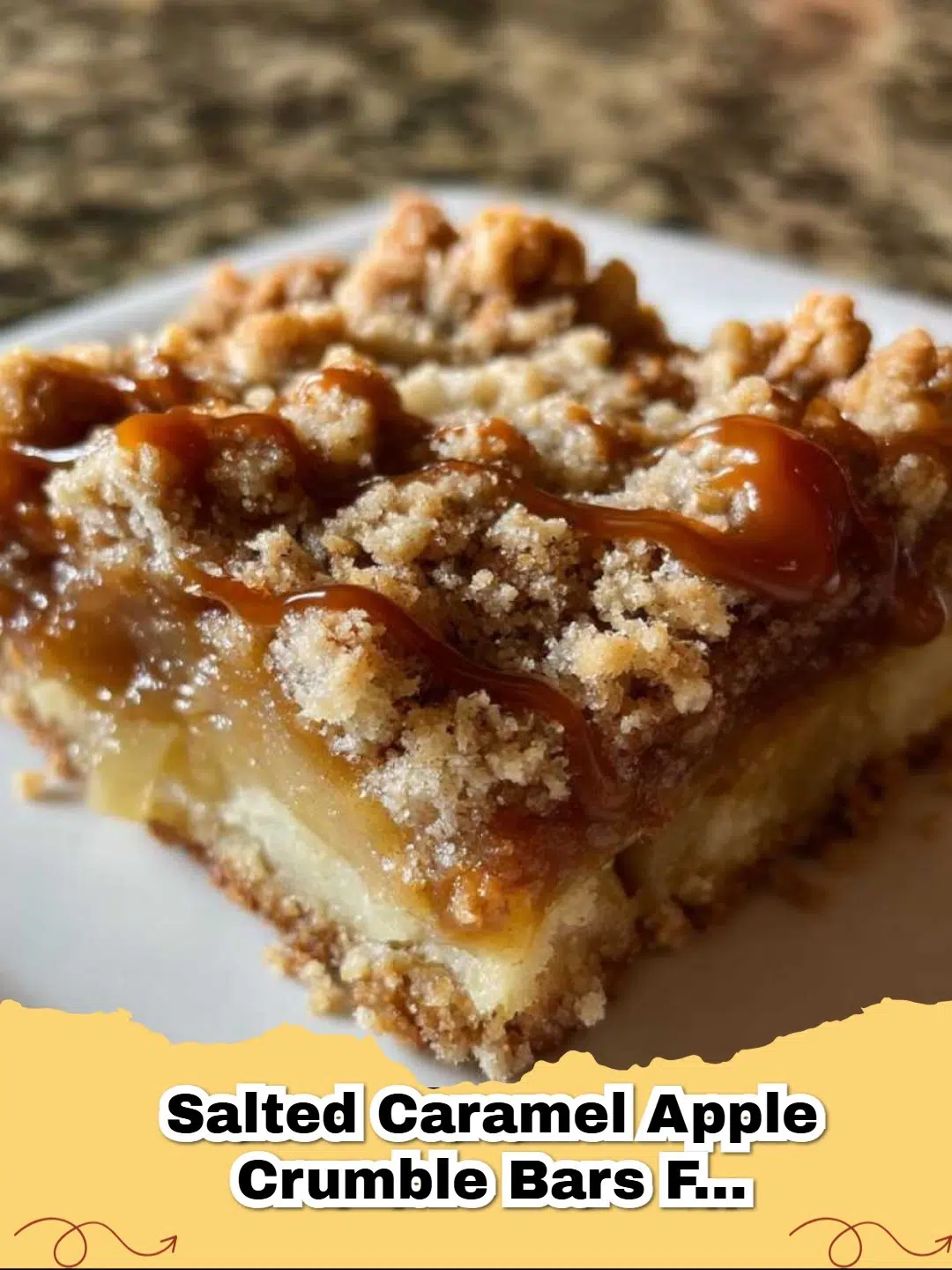 Close-up of golden brown Salted Caramel Apple Crumble Bars in a pan, generously drizzled with gooey salted caramel sauce.