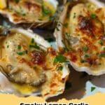 Close-up of freshly grilled Smoky Lemon Garlic Oysters on the half shell, garnished with parsley and lemon wedges