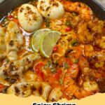 Bowl of spicy shrimp dumpling noodle soup with green onions and cilantro
