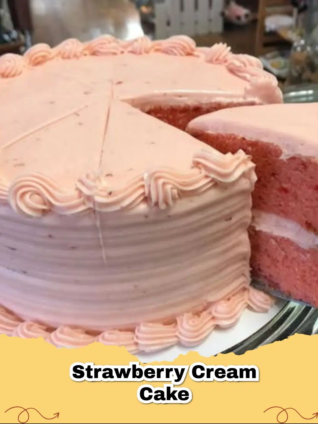 Close-up of a slice of moist Strawberry Jell-O Cake with pink cake layers and white cream cheese frosting, garnished with fresh strawberries.