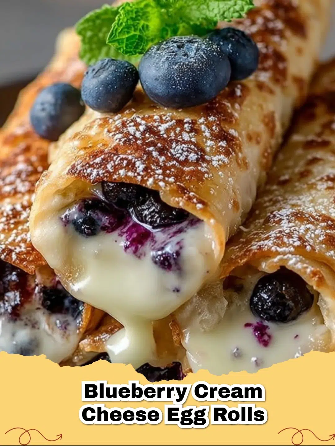 Crispy sweet blueberry cream cheese egg rolls dusted with powdered sugar on a white plate