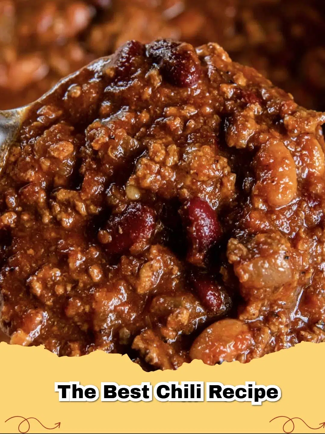 A close-up of The Best Ground Beef Chili recipe served in a bowl with shredded cheese and cilantro