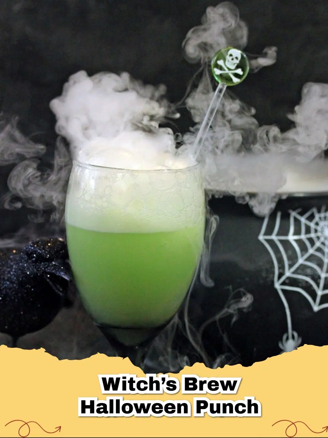 Vibrant green Witch's Brew Halloween Punch in a large punch bowl with spooky garnishes like gummy worms and dry ice smoke.