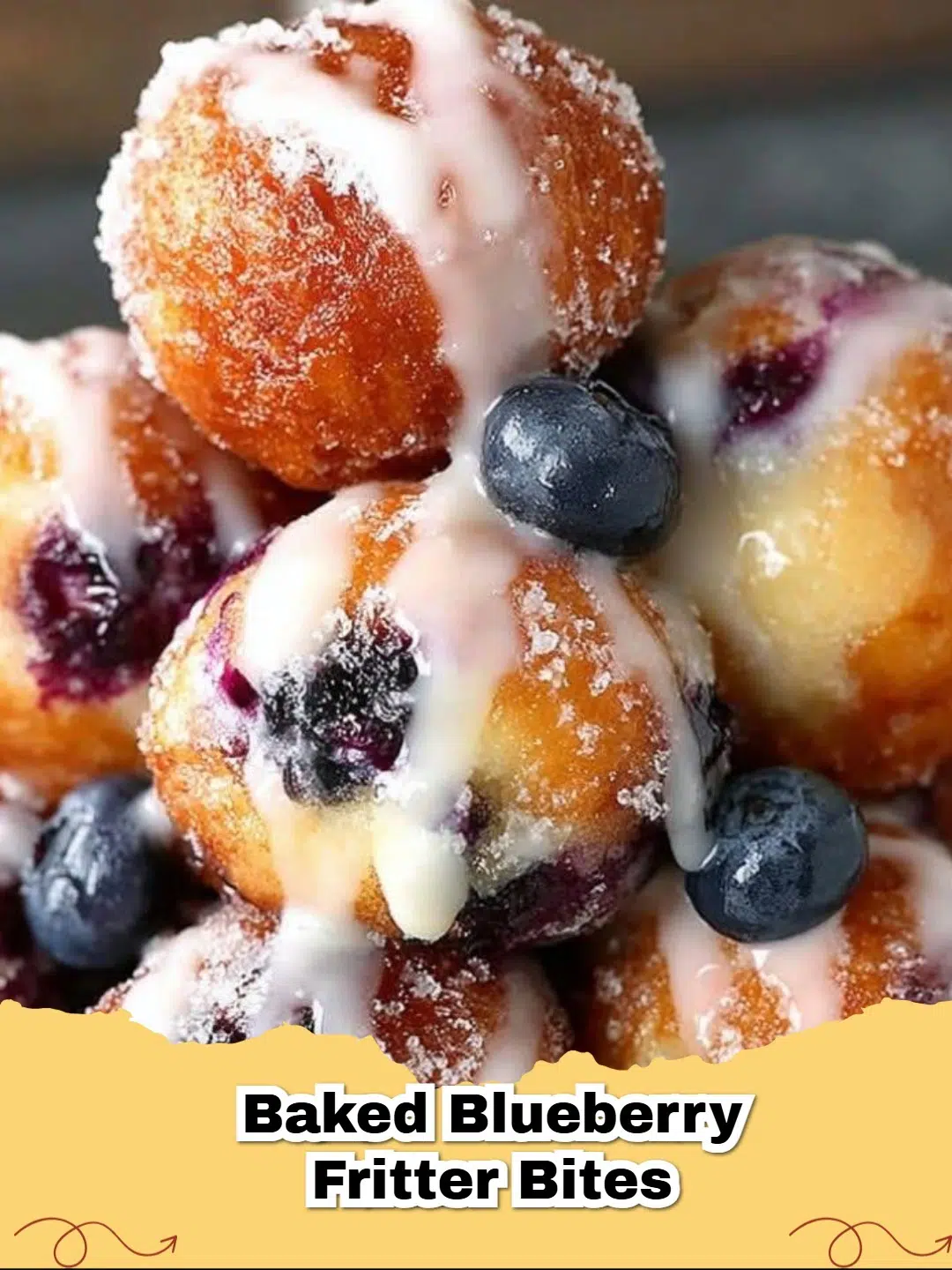 Close-up of golden brown Baked Blueberry Fritter Bites drizzled with white glaze on a wire rack.