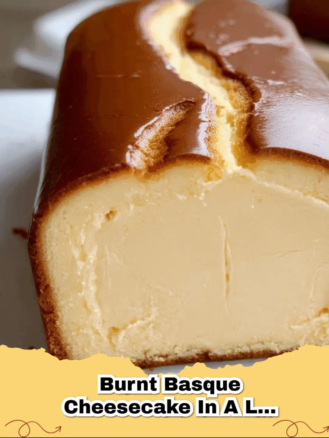 Close-up of a rustic, deeply caramelized Burnt Basque Cheesecake in a loaf pan, showing its creamy interior.
