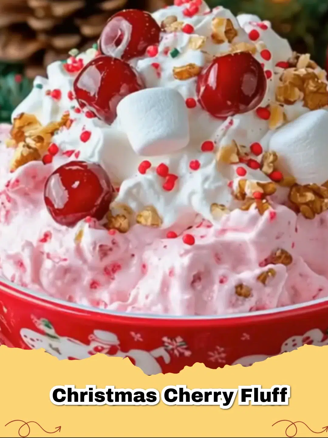 A close-up of a vibrant Christmas Cherry Fluff Salad in a clear glass bowl, garnished with a sprig of mint and a few whole cherries, ready for a holiday feast.