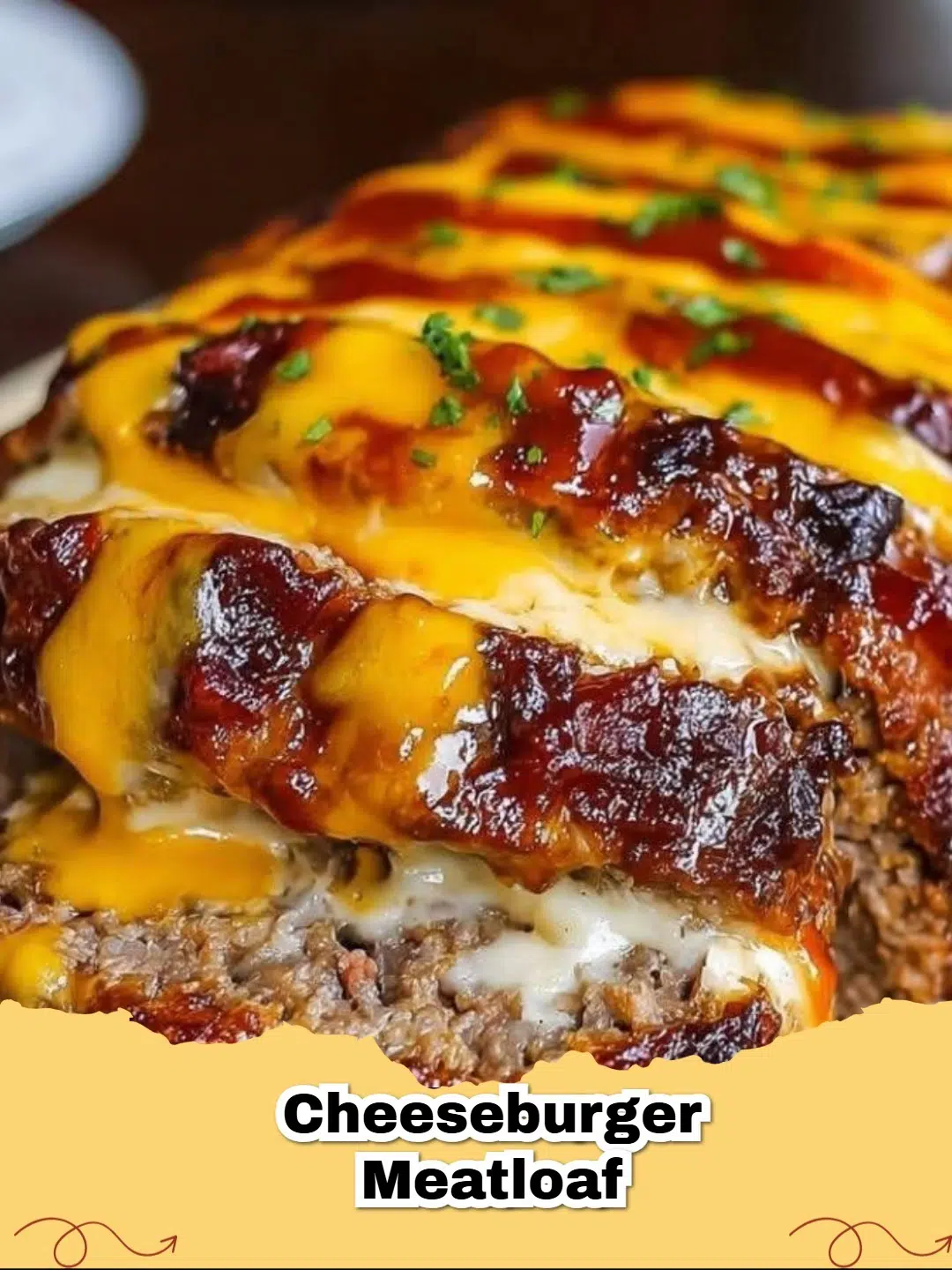 Delicious Classic Cheeseburger Meatloaf topped with melted cheddar cheese, ready to be sliced and served.
