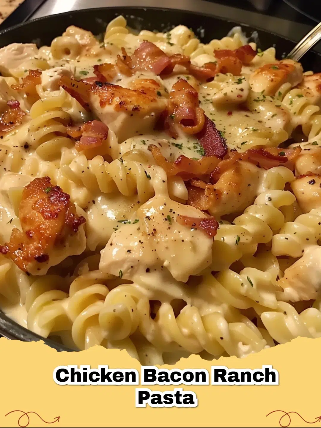 Creamy Chicken Bacon Ranch Pasta dish with rotini, crispy bacon, and fresh parsley garnish