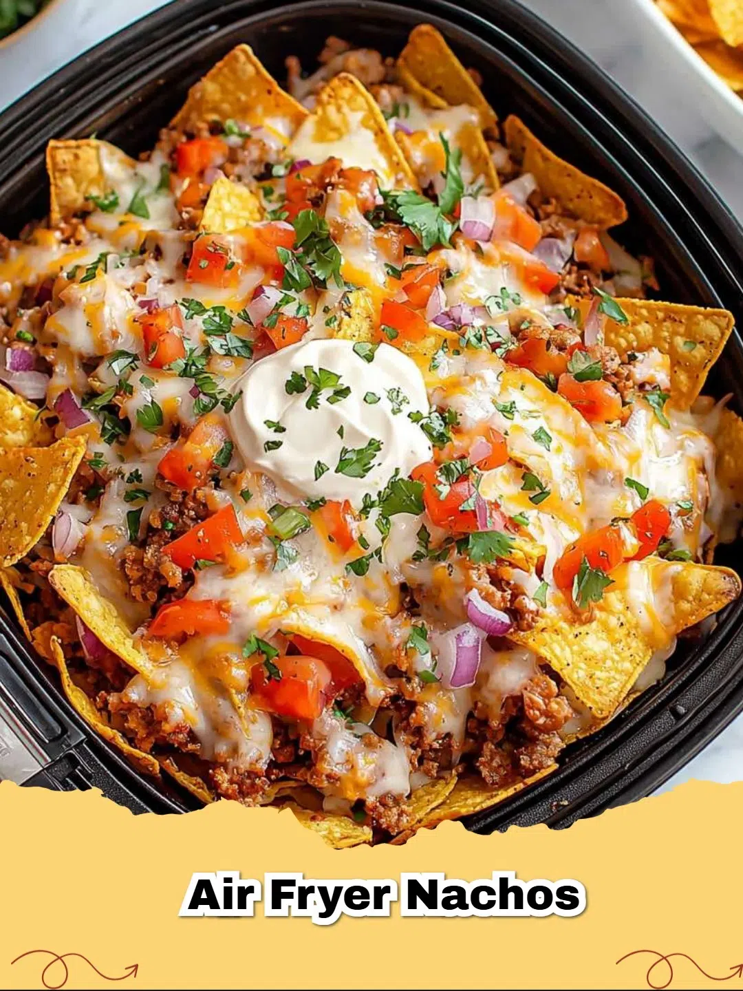 Pile of crispy Air Fryer Taco Nachos with melted cheese, seasoned beef, jalapeƱos, and cilantro.