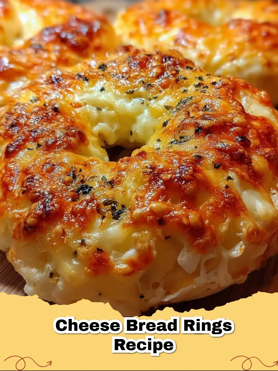 Close-up of golden brown, bubbly Easy Cheesy Bread Rings topped with herbs, on a baking sheet.