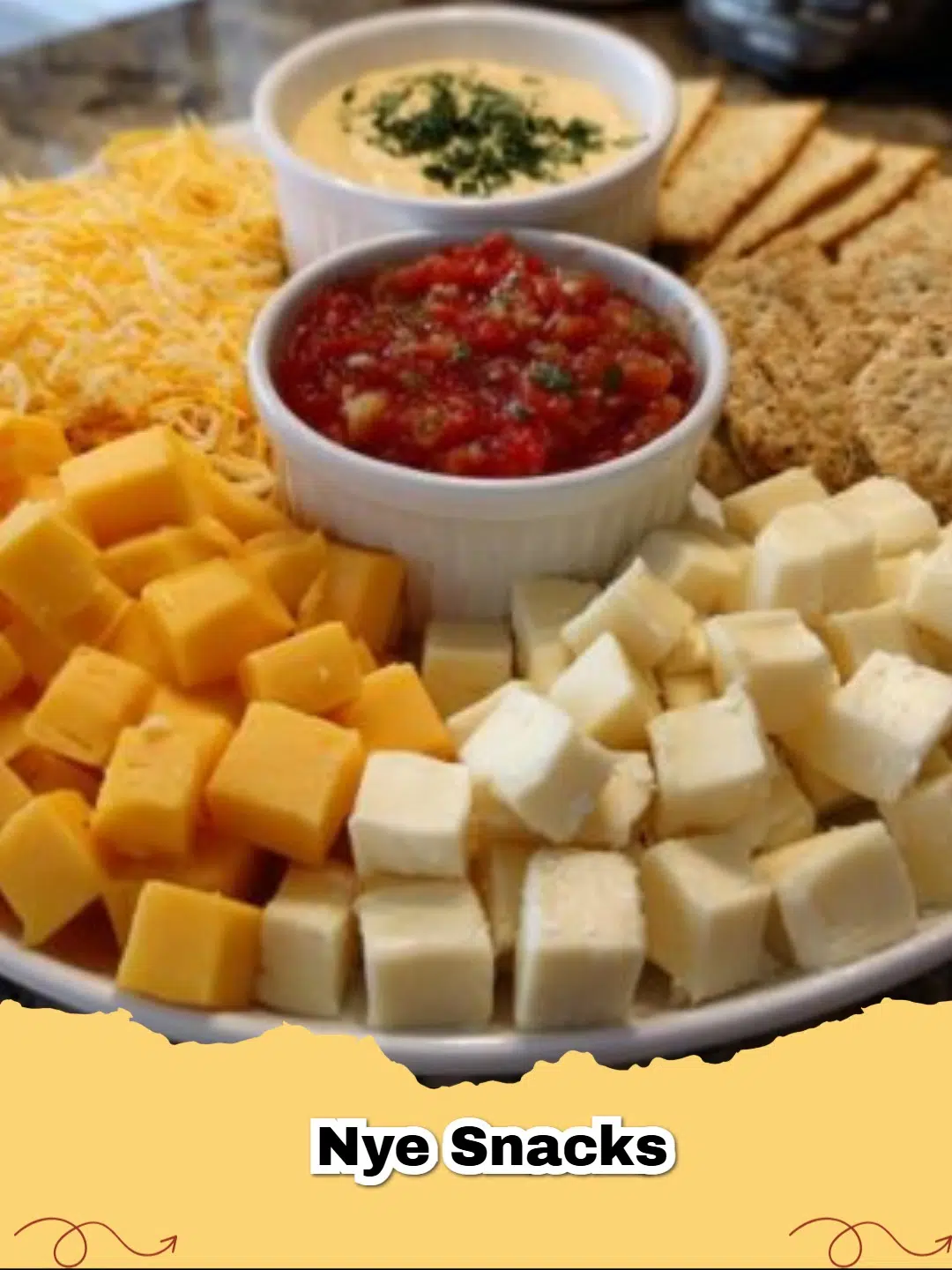 A vibrant New Year's Eve snack platter featuring a variety of cheeses, creamy ranch dip, salsa, and assorted crackers.