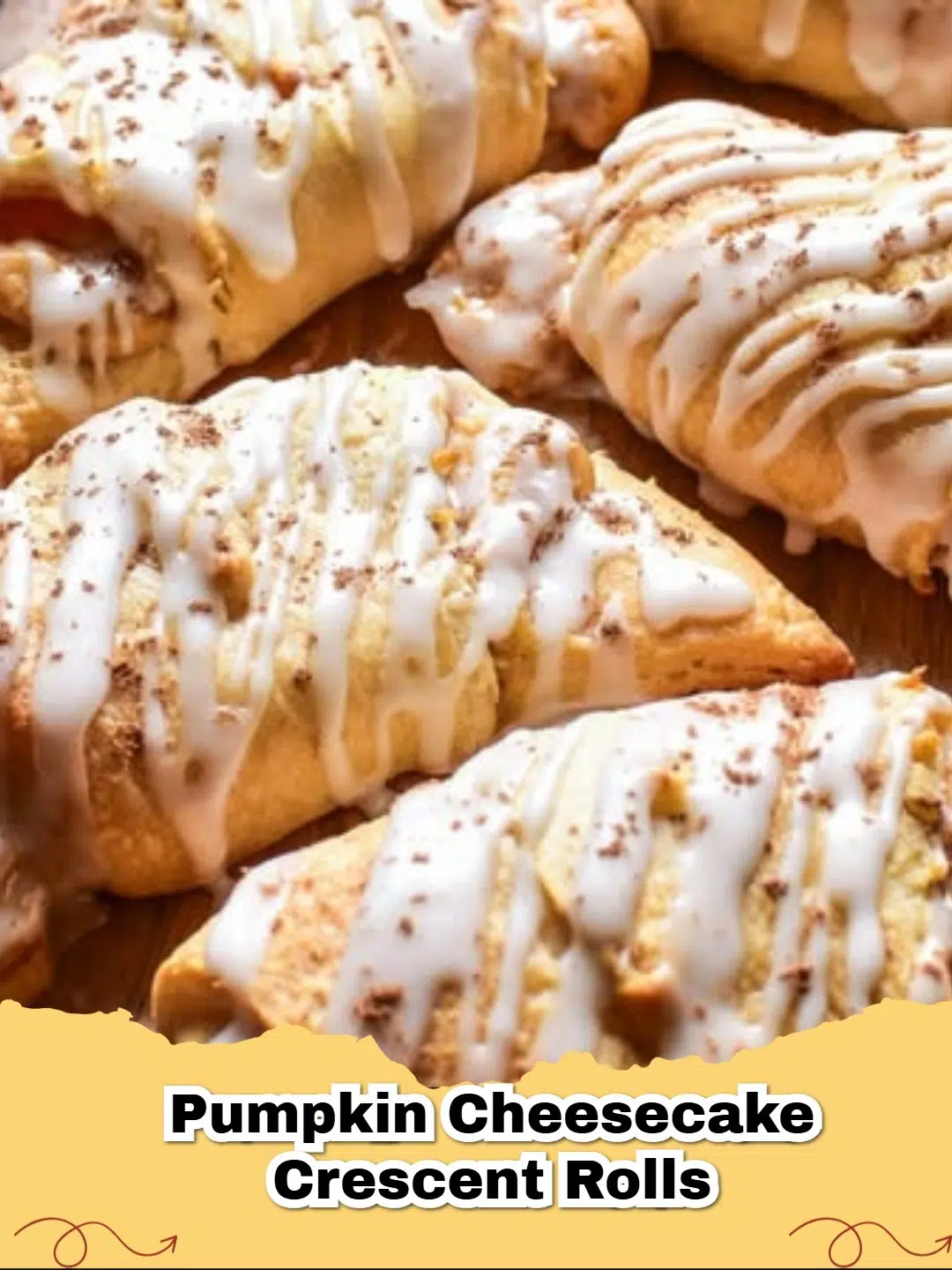 Golden brown Pumpkin Cheesecake Crescent Rolls drizzled with vanilla glaze on a wire rack, a perfect fall treat.