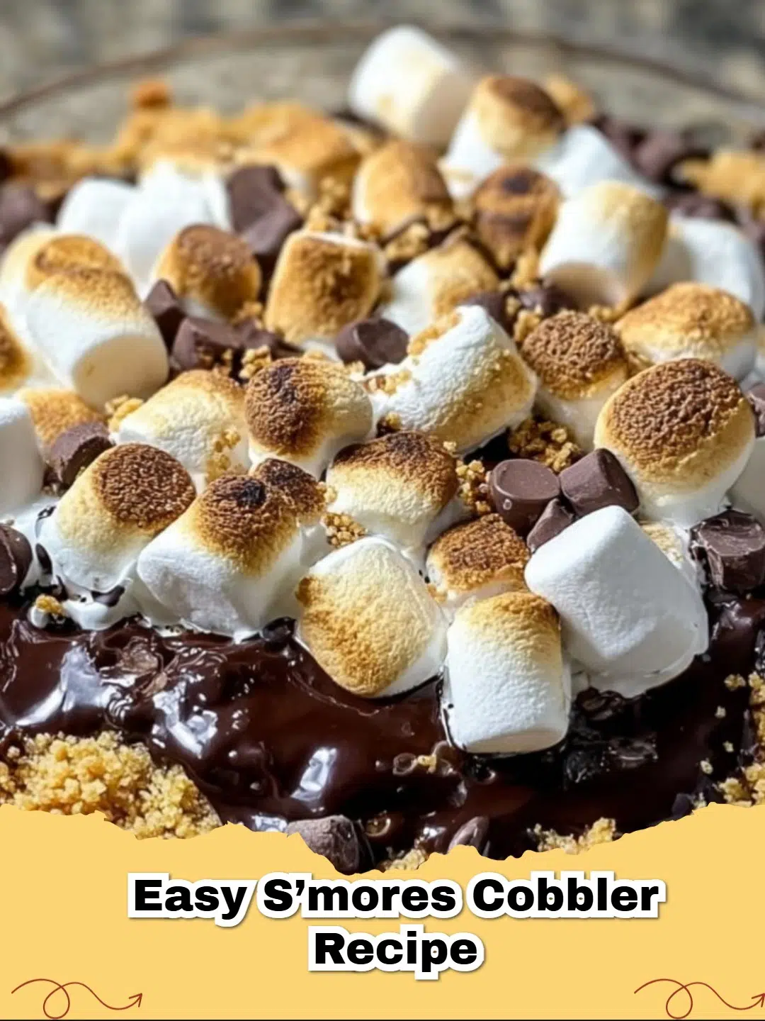 Easy S'mores Cobbler in a baking dish with golden brown marshmallows and melted chocolate.