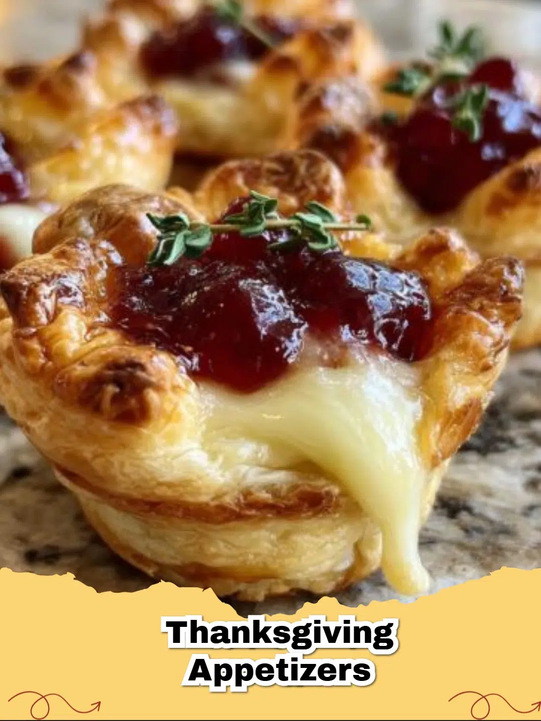 Close-up of golden brown Easy Thanksgiving Cranberry Brie Bites with fresh thyme garnish