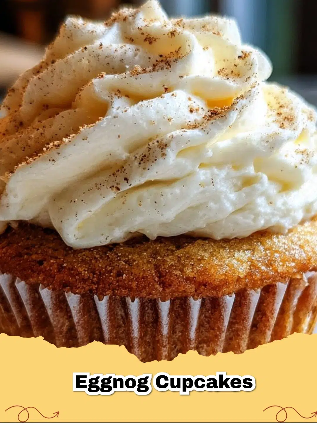 Festive eggnog cupcakes topped with creamy eggnog frosting and a sprinkle of nutmeg.